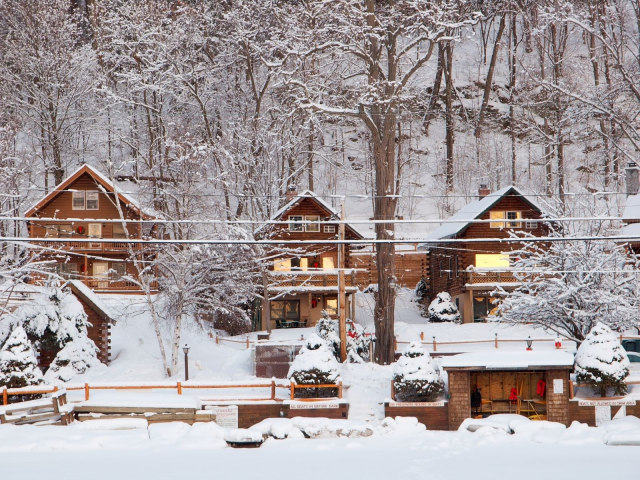 Snowy cabins viewed from the lake